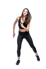 Fototapeta premium A slender woman in sportswear does exercises. Beautiful brunette in black leggings and top. Health, sports and slimness. Full height. Isolated on a white background. Vertical.