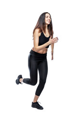 A slender woman in sportswear does exercises. Beautiful brunette in black leggings and top. Health, sports and slimness. Full height. Isolated on a white background. Vertical.