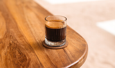 Mustard black coffee on a wooden table. Strong coffee for breakfast. A stylish concept for...