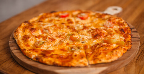 Banner of pizza on wooden tray. Delicious Margherita pizza cut into pieces. Appetizing Italian food concept