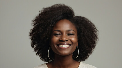 Beauty portrait of african american woman with clean healthy skin on beige background. Smiling beautiful afro girl. Curly black hair
