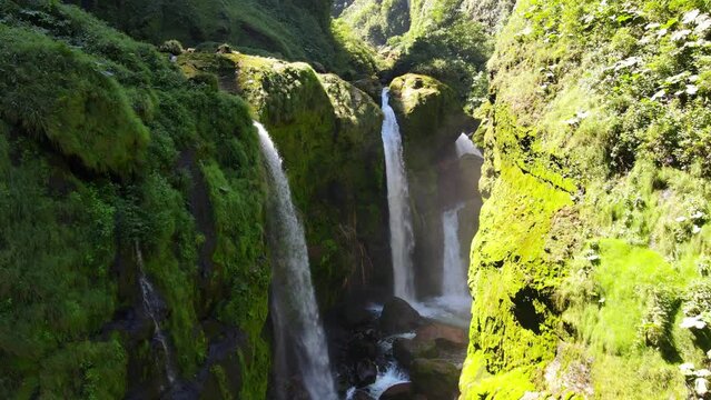 View amazing Quebrada Gata waterfall pourings tons of water into rocks in Alajuela Province, Costa Rica.