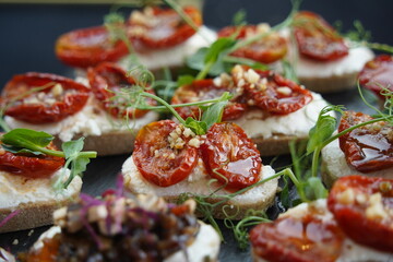 Mini snacks with various vegetables and herbs are on the table