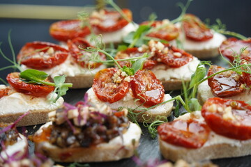 Mini snacks with various vegetables and herbs are on the table