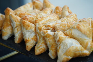Samsa with meat filling is laid out on the table