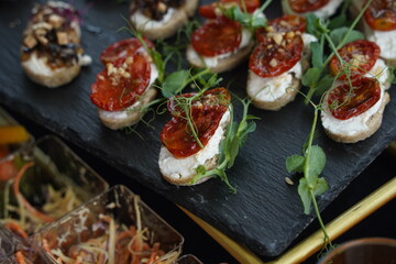 Mini snacks with various vegetables and herbs are on the table