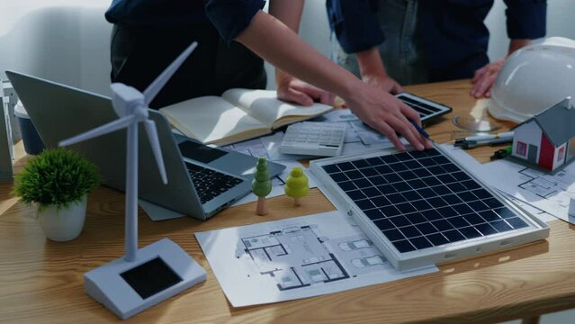 Working and brainstorming for cost estimating on paperworks and floor plan drawings about solar power energy system design to electricity and heat architectural and engineering for houses and building