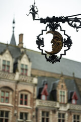 Fototapeta na wymiar Bruges in Belgium. Half moon symbol on the entrance of an museum.