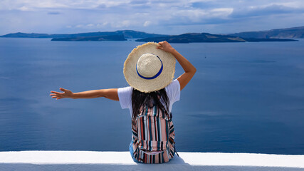 Happy lifestyle young tourist woman feeling freedom as looking view of aegean sea   travel with hat...