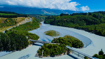 Fototapeta premium Aerial view of the Crossing bridge in the river from the the mountain forest