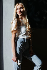 Woman with smartphone by the window. Contrast of light