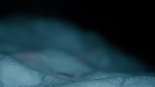 Cinematic Close up of a snow during a cold winter night in slow motion shot in 4K.