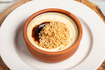 Rice pudding. Milky dessert. Oven-baked rice pudding dessert in a clay bowl. Close up