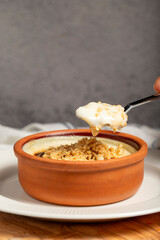 Rice pudding. Milky dessert. Oven-baked rice pudding dessert in a clay bowl