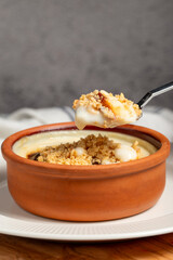 Rice pudding. Milky dessert. Oven-baked rice pudding dessert in a clay bowl. Close up