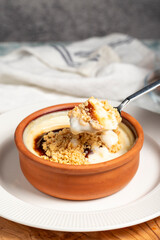 Rice pudding. Milky dessert. Oven-baked rice pudding dessert in a clay bowl
