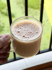 Top view of Indian Chai or traditional beverage milk tea and spices Kerala India. Cup of organic ayurvedic or herbal drink India, good in winter for immunity boosting.