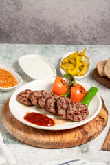 Grilled meat balls. With Tomatoes, Peppers, Appetizers and Special Sauce. Turkish meatballs on a plate. Close up