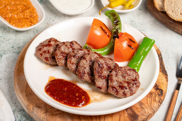 Grilled meat balls. With Tomatoes, Peppers, Appetizers and Special Sauce. Turkish meatballs on a plate