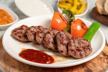 Grilled meat balls. With Tomatoes, Peppers, Appetizers and Special Sauce. Turkish meatballs on a...