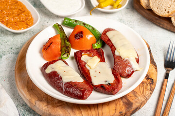 Grilled sausage. With Tomatoes, Peppers, Appetizers and Special Sauce. Grilled sausage with melted kashar on top