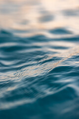 Beautiful closeup sea water surface. Sunset sunrise gold blue colors calm soft waves relaxing...