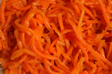 Grated carrot background, top view