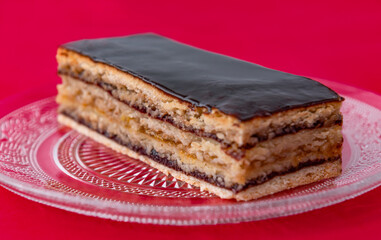 cake with nuts and marmalade, in layers, on a red background, Greta Garbo