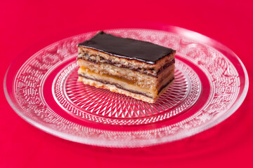 cake with nuts and marmalade, in layers, on a red background, Greta Garbo
