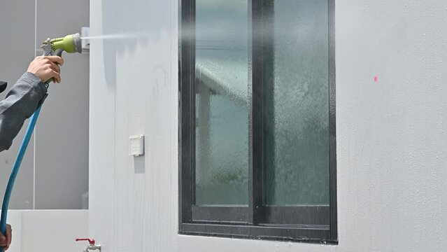 Engineer using hose for testing window leak by spray water. Home inspection concepts. The home inspection is your last chance to uncover defects with the house.
