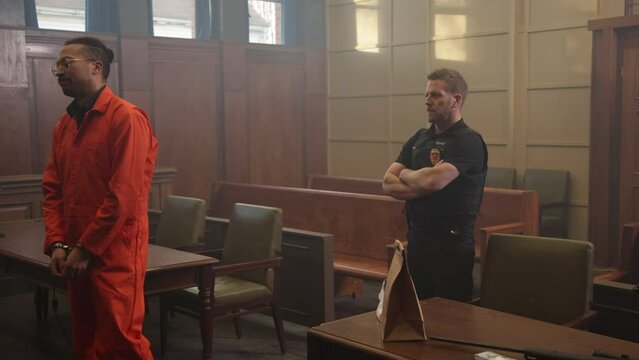 Court room scene with police and inmate