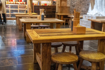 Fototapeta na wymiar Cozy Wooden Table Setting in Traditional Asian Restaurant