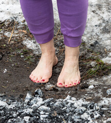 people walk with their feet on hot coals as a background.