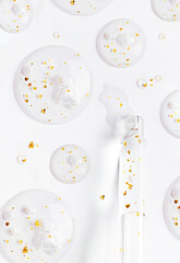 close-up of a serum pipette Serum gel essence texture with gold on white background