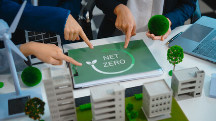 Sustainable business meetings at desks, green energy concepts. People in business suits discussing...