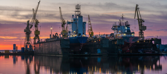 Ship repair at the ship repair yard during a spectacular sunrise-panorama - 750422108