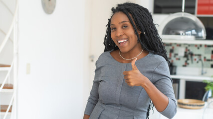 Black businesswoman with dreadlocks showing thumb up