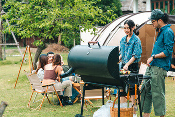 Group of diverse friend having outdoors bbq party together, camping activity lifestyle in summer,...