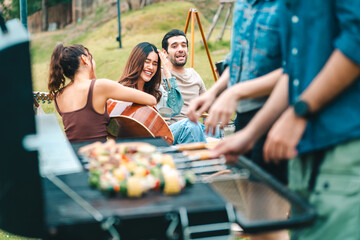 Group of diverse friend having outdoors bbq party together, camping activity lifestyle in summer, cooking fun and happy together with friends or family person group having relax in vacation time