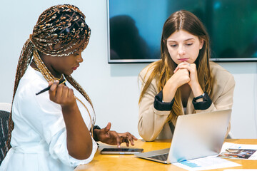 Group of marketing professionals having a meeting. Creative business team brainstorming with sticky notes. Happy business people putting their ideas together as they plan a project.