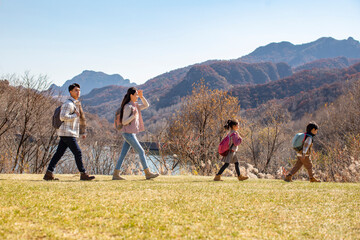 Happy young family hiking outdoors