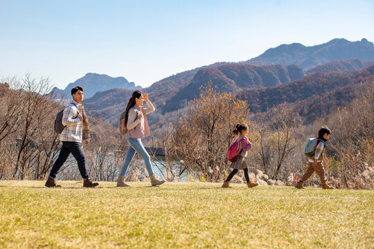 Happy young family hiking outdoors