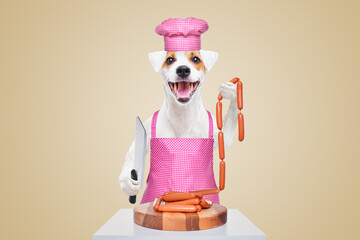 Portrait of a funny Jack Russell terrier in a kitchen apron and cap with a knife and a bunch of sausages in his hands