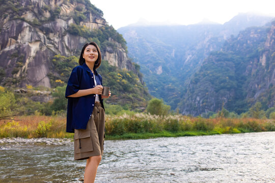 Cheerful young woman enjoying the beautiful natural scenery