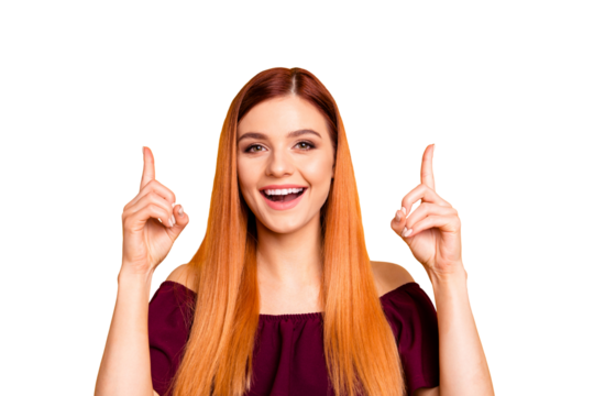 Red straight-haired attractive cute nice young girl showing pointing up with two fingers. Isolated over bright vivid yellow background