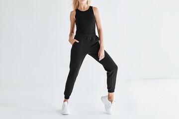 Fit Girl Pairs Dark Pants with Modern Joggers for Fashion Studio Session