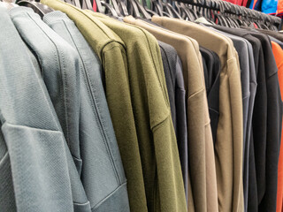 Rack of clothes with a variety of colors and styles - 750437957