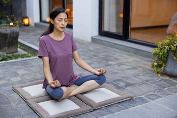 Mature woman doing yoga outdoors