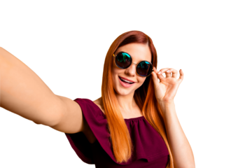 Self-portrait of red straight-haired attractive cute nice cheerful young girl, wearing round sun glasses, having fun. Isolated over bright vivid yellow background