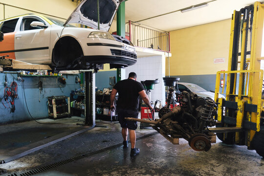 Auto mechanic standing near car at workshop